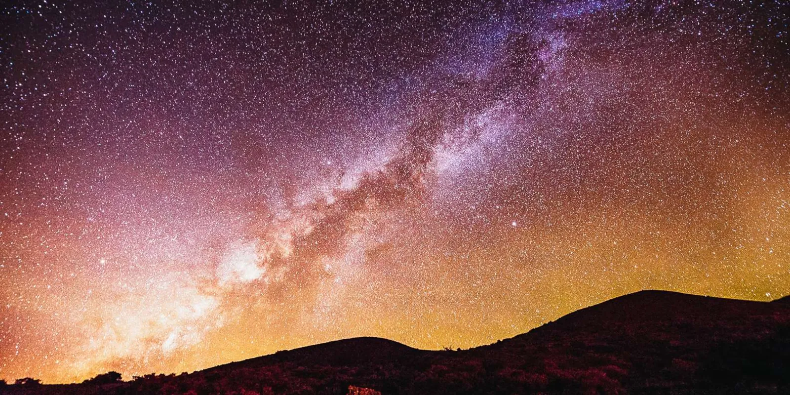 Night sky from Mauna Kea showing star trails above the cloud sea