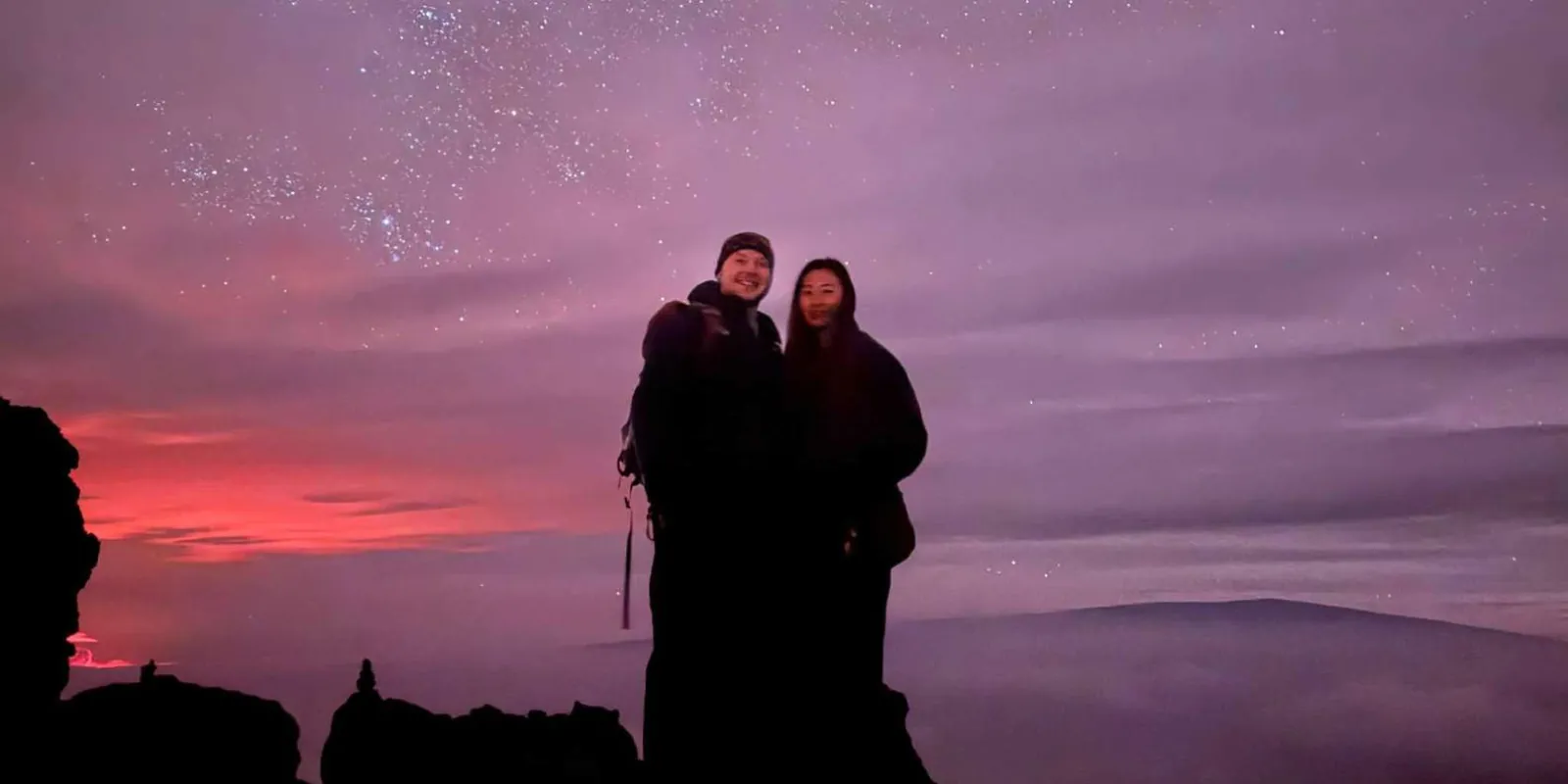 Guests seated on the volcanic slope listening to Hawaiian star navigation stories